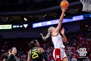 Nebraska Cornhusker forward Jessica Petrie (12) makes a layup agianst Oregon Duck guard Deja Kelly (25) in the fourth quarter during a college women’s basketball game Wednesday, February 19, 2025 in Lincoln, Nebraska. Photo by John S. Peterson.