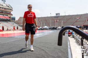 Nebraska Cornhusker head coach John Cook walks back inside after warm ups before ebraska Volleyball Day match in Lincoln, Nebraska, Wednesday, August 30, 2023. Photo by John Peterson.