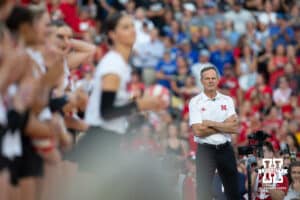 Nebraska head coach John Cook watching Merritt Beason wave to the fane during Nebraska Volleyball Day match against Omaha in Lincoln, Nebraska, Wednesday, August 30, 2023. Photo by John Peterson.