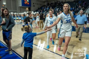 Creighton Bluejays Elizabeth Gentry high fives a young fan during a college basketball game against Seton Hall on February 5th, 2025 in Omaha Nebraska. Photo by Brandon Tiedemann.