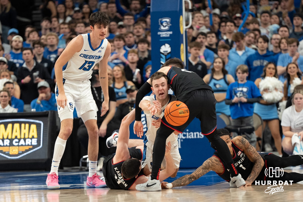 Creighton Bluejays Steven Ashworth looks to pass out of a jump ball during a college basketball game against UCONN on February 11th, 2025 in Omaha Nebraska. Photo by Brandon Tiedemann.