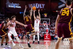 Nebraska Cornhusker guard Connor Essegian (0) makes a three-point shot against Minnesota Golden Gopher guard Femi Odukale (11) in the first half during a men’s college basketball game Saturday, March 1, 2025 in Lincoln, Nebraska. Photo by John S. Peterson.