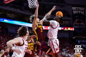 Nebraska Cornhusker forward Juwan Gary (4) makes a lay up against Minnesota Golden Gopher forward Dawson Garcia (3) in the first half during a men’s college basketball game Saturday, March 1, 2025 in Lincoln, Nebraska. Photo by John S. Peterson.