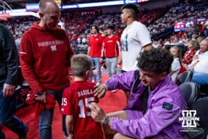 Nebraska Cornhuskers quarterback Dylan Raiola signs an autograph while watching the game against the Minnesota Golden Gophers during a men’s college basketball game Saturday, March 1, 2025 in Lincoln, Nebraska. Photo by John S. Peterson.