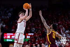 Nebraska Cornhusker guard Connor Essegian (0) makes a three-point shot against Minnesota Golden Gopher guard Femi Odukale (11) in the second half during a men’s college basketball game Saturday, March 1, 2025 in Lincoln, Nebraska. Photo by John S. Peterson.