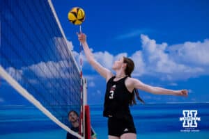 Nebraska Cornhusker Bergen Reilly (3) bumps the ball over the net against the Ottawa Braves during a college beach volleyball match Tuesday, March 4, 2025 in Lincoln, Nebraska. Photo by John S. Peterson.