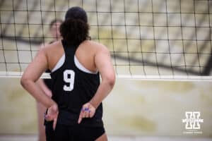 Nebraska Cornhusker Teraya Sigler (9) gives a signals to Bergen Reilly when serving against the Ottawa Braves during a college beach volleyball match Tuesday, March 4, 2025 in Lincoln, Nebraska. Photo by John S. Peterson.