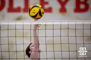 Nebraska Cornhusker Bergen Reilly (3) bumps the ball over the net against the Ottawa Braves during a college beach volleyball match Tuesday, March 4, 2025 in Lincoln, Nebraska. Photo by John S. Peterson.