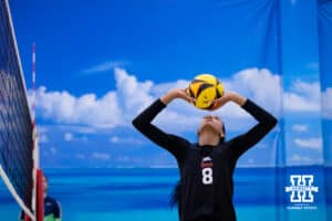 Nebraska Cornhusker Harper Murray (8) sets teh ball against the Ottawa Braves during a college beach volleyball match Tuesday, March 4, 2025 in Lincoln, Nebraska. Photo by John S. Peterson.