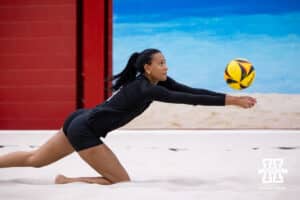 Nebraska Cornhusker Harper Murray (8) lunges to dig the ball against the Ottawa Braves during a college beach volleyball match Tuesday, March 4, 2025 in Lincoln, Nebraska. Photo by John S. Peterson.