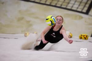 Nebraska Cornhusker Olivia Mauch (34) dives for the ball against the Ottawa Braves during a college beach volleyball match Tuesday, March 4, 2025 in Lincoln, Nebraska. Photo by John S. Peterson.