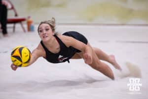 Nebraska Cornhusker Laney Choboy (13) dives for the ball against the Ottawa Braves during a college beach volleyball match Tuesday, March 4, 2025 in Lincoln, Nebraska. Photo by John S. Peterson.