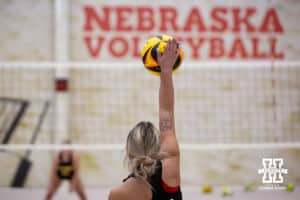 Nebraska Cornhusker Laney Choboy (13) serves the ball against the Ottawa Braves during a college beach volleyball match Tuesday, March 4, 2025 in Lincoln, Nebraska. Photo by John S. Peterson.