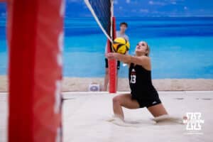 Nebraska Cornhusker Laney Choboy (13) digs the ball against the Ottawa Braves during a college beach volleyball match Tuesday, March 4, 2025 in Lincoln, Nebraska. Photo by John S. Peterson.