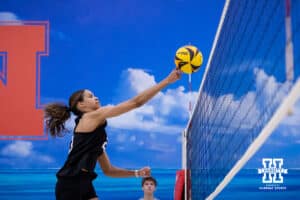 Nebraska Cornhusker Skyler Pierce (23) bumps the ball over the net against the Ottawa Braves during a college beach volleyball match Tuesday, March 4, 2025 in Lincoln, Nebraska. Photo by John S. Peterson.