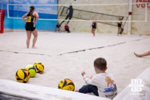 Nebraska Cornhusker Olivia Mauch (34) little bother plays in the sand during a college beach volleyball match Tuesday, March 4, 2025 in Lincoln, Nebraska. Photo by John S. Peterson.