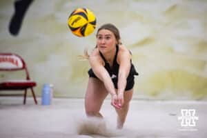 Nebraska Cornhusker Maisie Boesiger (2) dives for the ball against the Ottawa Braves during a college beach volleyball match Tuesday, March 4, 2025 in Lincoln, Nebraska. Photo by John S. Peterson.