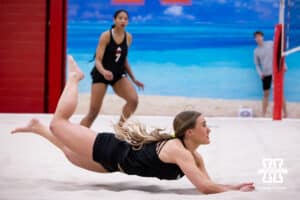 Nebraska Cornhusker Maisie Boesiger (2) dives for the ball against the Ottawa Braves during a college beach volleyball match Tuesday, March 4, 2025 in Lincoln, Nebraska. Photo by John S. Peterson.