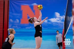 Nebraska Cornhusker Campbell Flynn (16) spikes the ball against the Ottawa Braves during a college beach volleyball match Tuesday, March 4, 2025 in Lincoln, Nebraska. Photo by John S. Peterson.