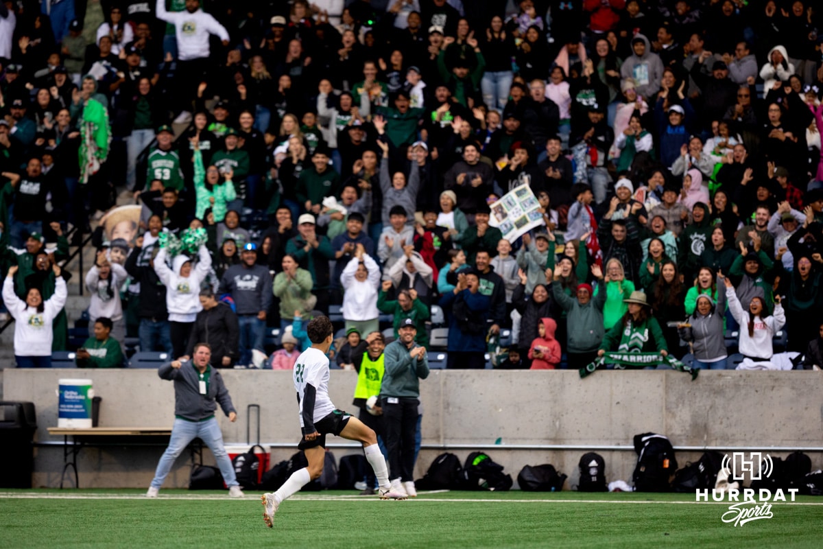 Schuyler Defender Richard Delgado (22) celebrates with the Schuyler crowd after a critical goal in the second half during the NSAA Boys Class B soccer finals on Tuesday, May 20, 2025, in Omaha, Nebraska. Photo by Braden Cochran.