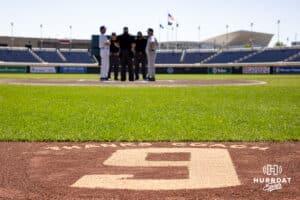 Creighton Bluejays head coach Ed Servais' last home game there's a number nine on the warning track as the coaches meet at home plate before a college baseball game on Sunday, May 11, 2025 in Omaha, Nebraska. Photo by John S. Peterson.