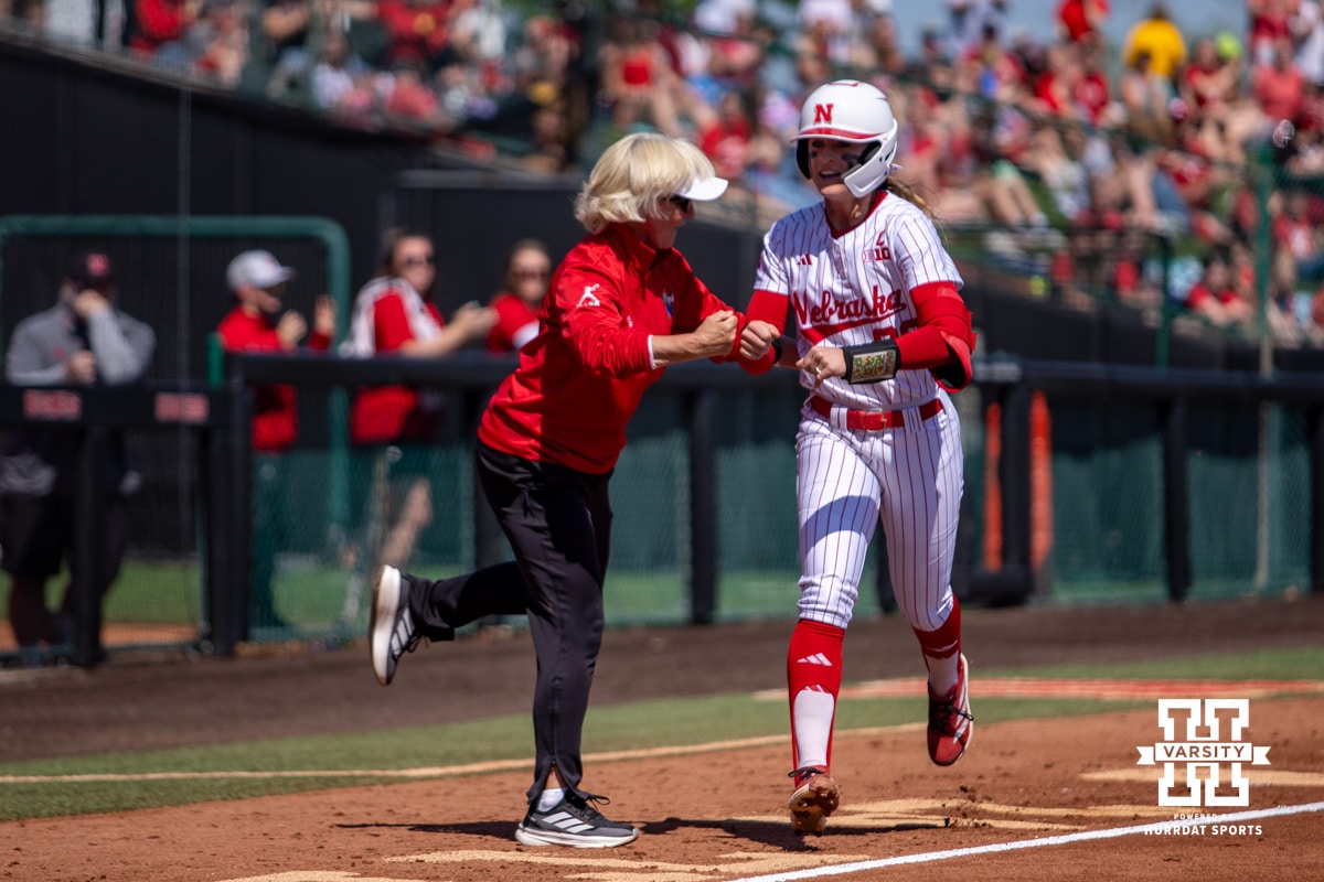 Nebraska Cornhusker Jordyn Bahl (98) gets a fist bump rounding third after hitting a home run against the Maryland Terrapins during a college softball game on Sunday, May 4, 2025 in Lincoln, Nebraska. Photo by John S. Peterson.