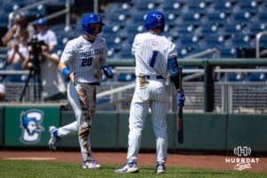 Creighton Bluejay outfielder Tate Gillen (20) celebrates a run with Nolan Sailors against the Xavier Musketeers during a college baseball game on Sunday, May 11, 2025 in Omaha, Nebraska. Photo by John S. Peterson.