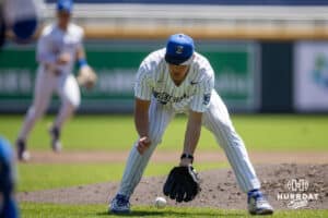 Creighton Bluejay pitcher Wilson Magers (33) scoops up the ball to throw to first for an out against the Xavier Musketeers in the thrid inning during a college baseball game on Sunday, May 11, 2025 in Omaha, Nebraska. Photo by John S. Peterson.