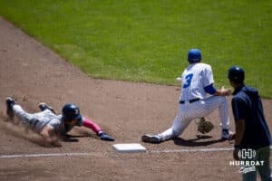 Xavier Musketeer infielder Luke Hammond (3) slides to third base against Creighton Bluejay utility Matt Scherrman (3) in the seventh inning during a college baseball game on Sunday, May 11, 2025 in Omaha, Nebraska. Photo by John S. Peterson.