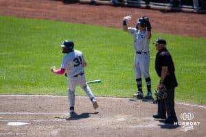 Xavier Musketeer infielder Nolan Tucker (1) and Carter Hendrickson score against the Creighton Bluejays in the seventh inning during a college baseball game on Sunday, May 11, 2025 in Omaha, Nebraska. Photo by John S. Peterson.