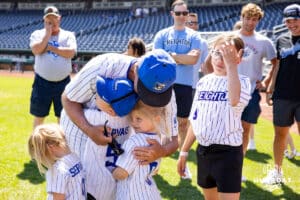 Creighton Bluejays head coach Ed Servais give his grandkids at hug afte the game against Xavier Musketeers during a college baseball game on Sunday, May 11, 2025 in Omaha, Nebraska. Photo by John S. Peterson.