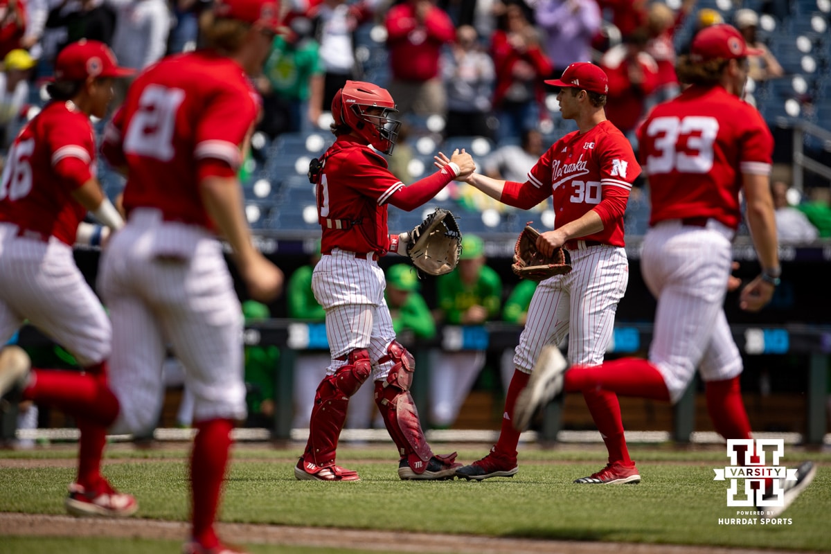 Nebraska Cornhusker pitcher Will Walsh (30) and catcher Hogan Helligso give each other an hug after the win over the Oregon Ducks during the Big Ten Baseball Tournament on Saturday, May 24, 2025 in Omaha, Nebraska. Photo by John S. Peterson.