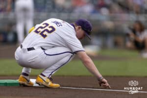 LSU Tiger first baseman Jared Jones (22) draws in the dirt before the first pitch against the Arkansas Razorbacks during the College World Series on Wednesday, June 18, 2025 in Omaha, Nebraska. Photo by John S. Peterson.