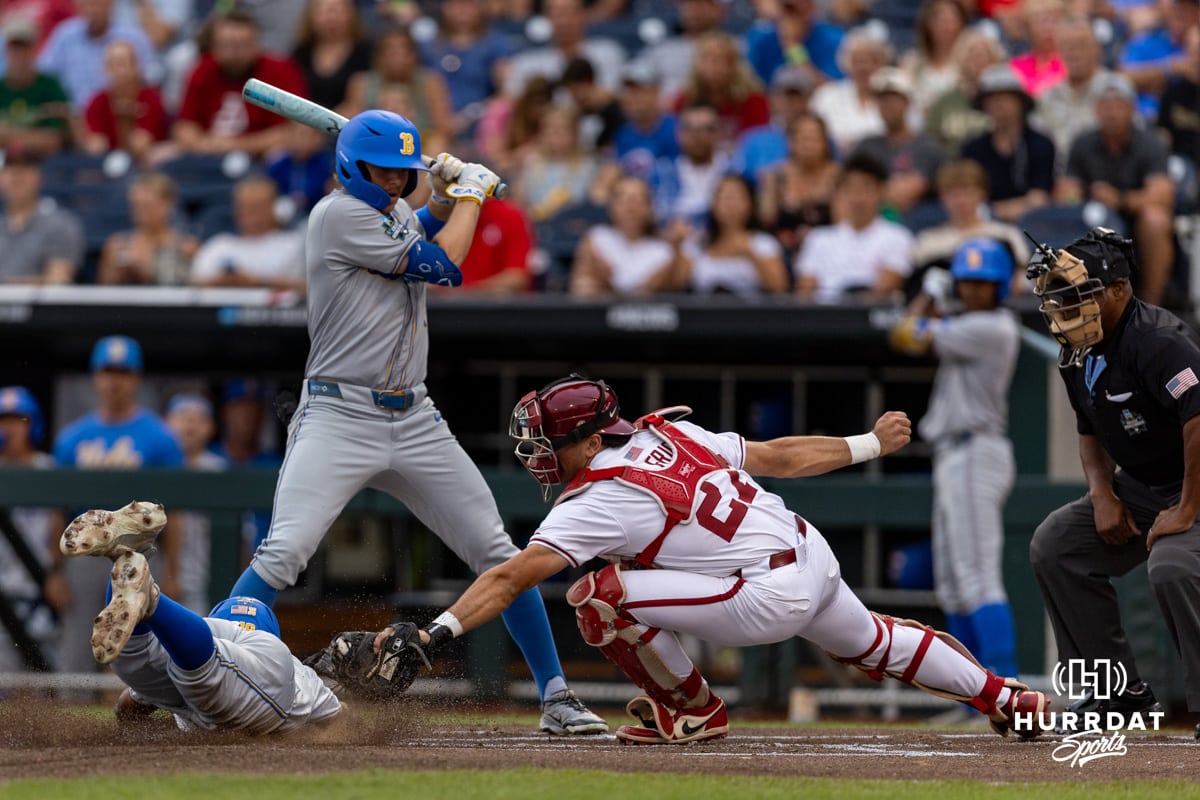 Arkansas Razorback catcher Ryder Helfrick (27) tags UCLA Bruin outfielder Dean West (36) out at home in the first inning during the College World Series on Tuesday, June 17, 2025 in Omaha, Nebraska. Photo by John S. Peterson.