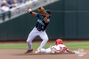 Louisville Cardinal Alex Alicea (0) steals second against Coastal Carolina Chanticleer infielder Ty Dooley (3) in the first inninnnnn; during the College World Series on Wednesday, June 18, 2025 in Omaha, Nebraska. Photo by John S. Peterson.