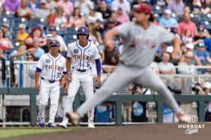 LSU Tiger outfielder Derek Curiel (6) leads off third base while Arkansas Razorback pitcher Landon Beidelschies (35) throws a pitch in the first inning during the College World Series on Wednesday, June 18, 2025 in Omaha, Nebraska. Photo by John S. Peterson.