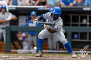 UCLA Bruin outfielder Dean West (36) lays down a SAC bunt against the LSU Tigers in the second inning during the College World Series on Monday, June 16, 2025 in Omaha, Nebraska. Photo by John S. Peterson.