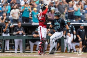 Coastal Carolina Chanticleer catcher Caden Bodine (17) driving in for a run against the Louisville Cardinals in the first inning during the College World Series on Wednesday, June 18, 2025 in Omaha, Nebraska. Photo by John S. Peterson.