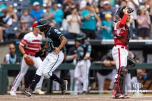Coastal Carolina Chanticleer outfielder Sebastian Alexander (1) scores a run in the first inning against the Louisville Cardinals during the College World Series on Wednesday, June 18, 2025 in Omaha, Nebraska. Photo by John S. Peterson.