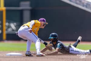 Coastal Carolina Chanticleer outfielder Sebastian Alexander (1) steals second base agaisnt LSU Tiger infielder Daniel Dickinson (14) in the first inning in the second game of the finals during the College World Series on Sunday, June 22, 2025 in Omaha, Nebraska. Photo by John S. Peterson.