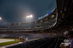 Fans take cover from the rain during the College World Series game between the LSU Tigers and the UCLA Bruins on Monday, June 16, 2025 in Omaha, Nebraska. Photo by John S. Peterson.