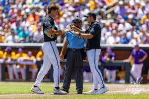 Coastal Carolina Chanticleer pitcher Jacob Morrison (51) get tech help in the third inning against the LSU Tigers in the second game of the finals during the College World Series on Sunday, June 22, 2025 in Omaha, Nebraska. Photo by John S. Peterson.