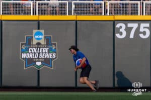 Grounds crew member picks a beach ball during the College World Series game between the LSU Tigers and the Arkansas Razorbacks on Wednesday, June 18, 2025 in Omaha, Nebraska. Photo by John S. Peterson.