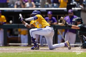LSU Tiger infielder Michael Braswell (10) lays down a bunt to advance Dickenson to second base against the Coastal Carolina Chanticleers in the third inning in the second game of the finals during the College World Series on Sunday, June 22, 2025 in Omaha, Nebraska. Photo by John S. Peterson.