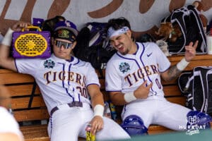 LSU Tiger catcher Edward Yamin IV (30) and Cade Arrambide listening to AC/DC before the restart of the game against UCLA Bruins during the College World Series on Tuesday, June 17, 2025 in Omaha, Nebraska. Photo by John S. Peterson.
