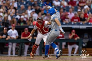 Arkansas Razorback catcher Ryder Helfrick (27) finishes the strike out against UCLA Bruin A.J. Salgado (24) during the College World Series on Tuesday, June 17, 2025 in Omaha, Nebraska. Photo by John S. Peterson.
