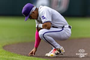 LSU Tiger infielder Steven Milam (4) draws in the dirt before the re-start of the game against the UCLA Bruins in the third inning during the College World Series on Tuesday, June 17, 2025 in Omaha, Nebraska. Photo by John S. Peterson.