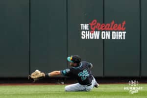 Coastal Carolina Chanticleer outfielder Wells Sykes (20) attempts to catch a ball during a baseball game Thursday June 18th 2025 in Omaha Nebraska. Photo by Brandon Tiedemann.