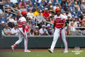 Louisville Cardinal Jake Munroe (20) walks back to the dugout after striking out as Eddie King Jr. (42) takes his turn at bat against the Coastal Carolina Chanticleers in te fourth inning during the College World Series on Wednesday, June 18, 2025 in Omaha, Nebraska. Photo by John S. Peterson.