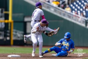 LSU Tiger infielder Steven Milam (4) jumps throwing to first base against UCLA Bruin infielder A.J. Salgado (24) in the fifth inning during the College World Series on Tuesday, June 17, 2025 in Omaha, Nebraska. Photo by John S. Peterson.
